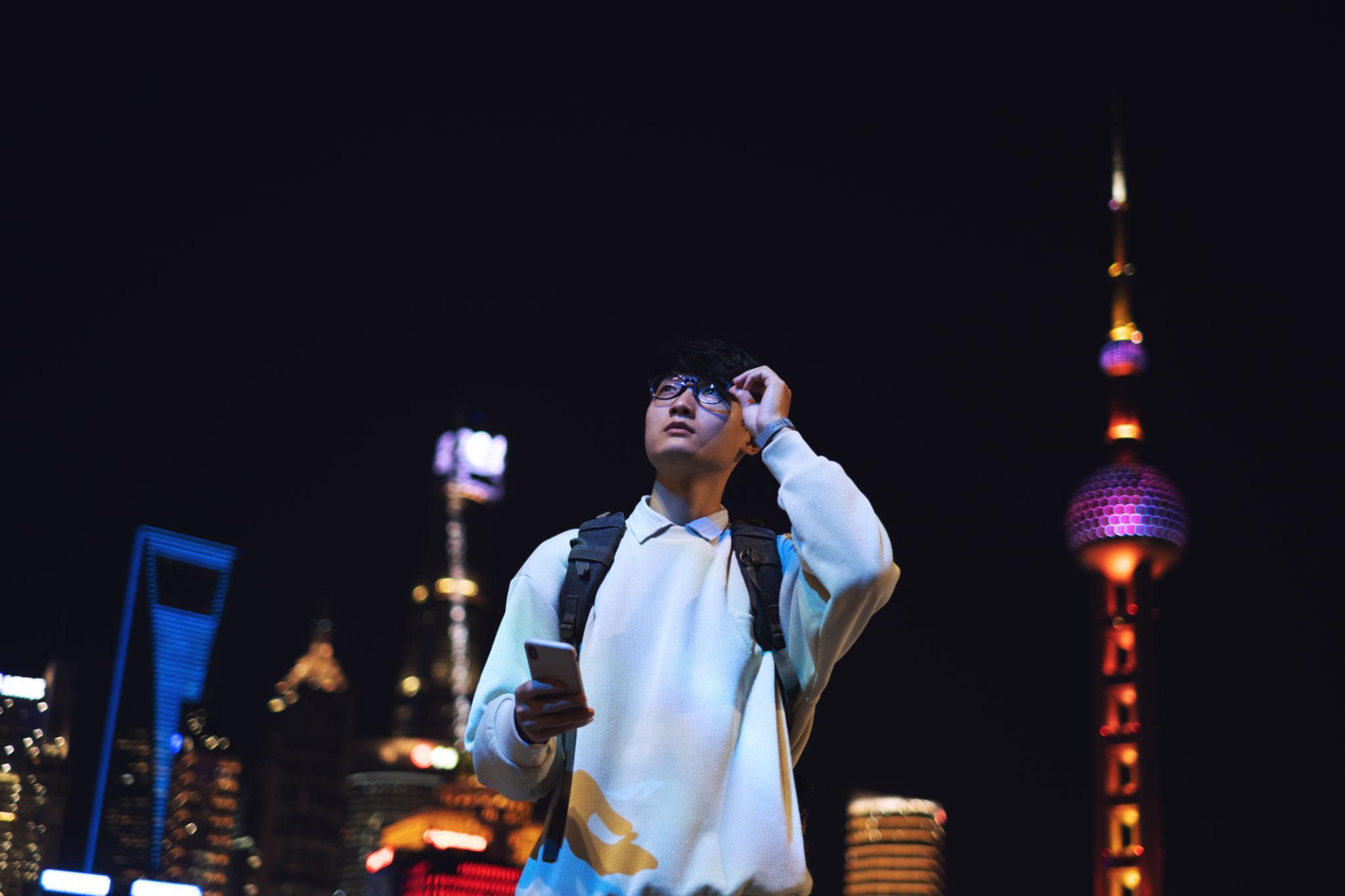 Traveler using phone in China with skyline in background